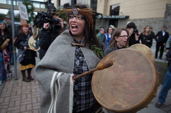 Audrey Siegl of the Musqueam First Nation chants and beats a drum during a protest outside National Energy Board hearings on the proposed Trans Mountain pipeline expansion in Burnaby, B.C., on Jan. 19, 2016. (THE CANADIAN PRESS/Darryl Dyck)