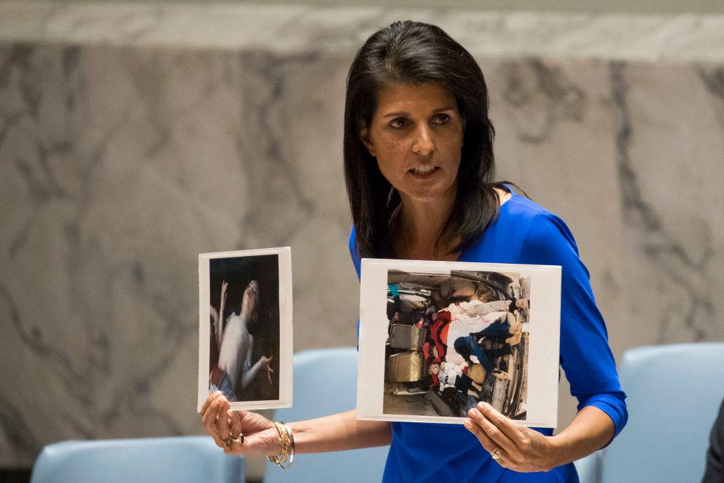 U.S. Ambassador to the United Nations Nikki Haley holds up photos of victims of the Syrian chemical attack during a meeting of the United Nations Security Council at U.N. headquarters in New York City on April 5, 2017. (Drew Angerer/Getty Images)