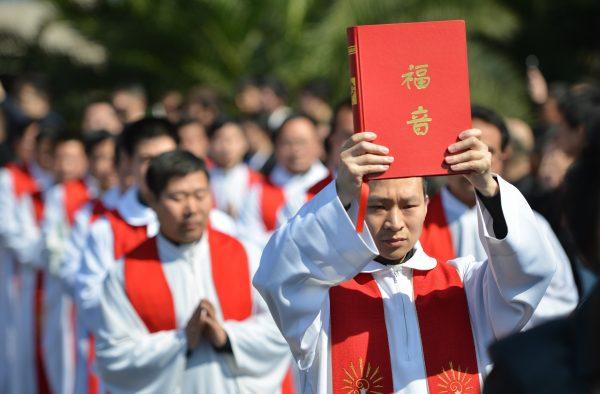 Funeral of Bishop Joseph Fan Zhongliang, the late head of the underground Catholic Church in Shanghai, in Shanghai on March 22, 2014. Many Chinese Catholics, in defiance of the Chinese regime, attend underground “house churches” instead of the regime-sanctioned Chinese Patriotic Catholic Association (CPCA) churches. (Peter Parks/AFP/Getty Images)