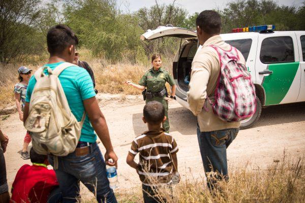 Marlene Castro, supervisory Border Patrol agent, speaks to a group of unaccompanied minors, a family unit, and another male who crossed the Rio Grande from Mexico in Hidalgo County, Texas, on May 26, 2017. (Benjamin Chasteen/The Epoch Times)