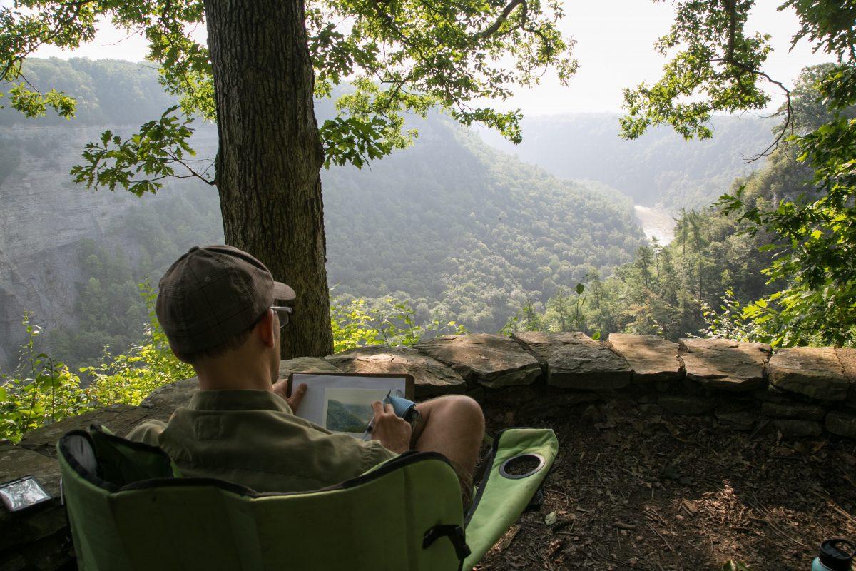 Thomas Kegler paints a color study for a larger painting in Letchworth State Park, N.Y., on Aug. 16, 2018. (Milene Fernandez/The Epoch Times)