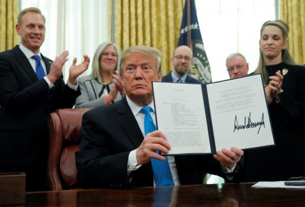 U.S. President Donald Trump displaus the "Space Policy Directive 4" after signing the directive establish a Space Force as the sixth branch of the Armed Forces in the Oval Office at the White House in Washington, U.S., on Feb.19, 2019. (Jim Young/REUTERS)