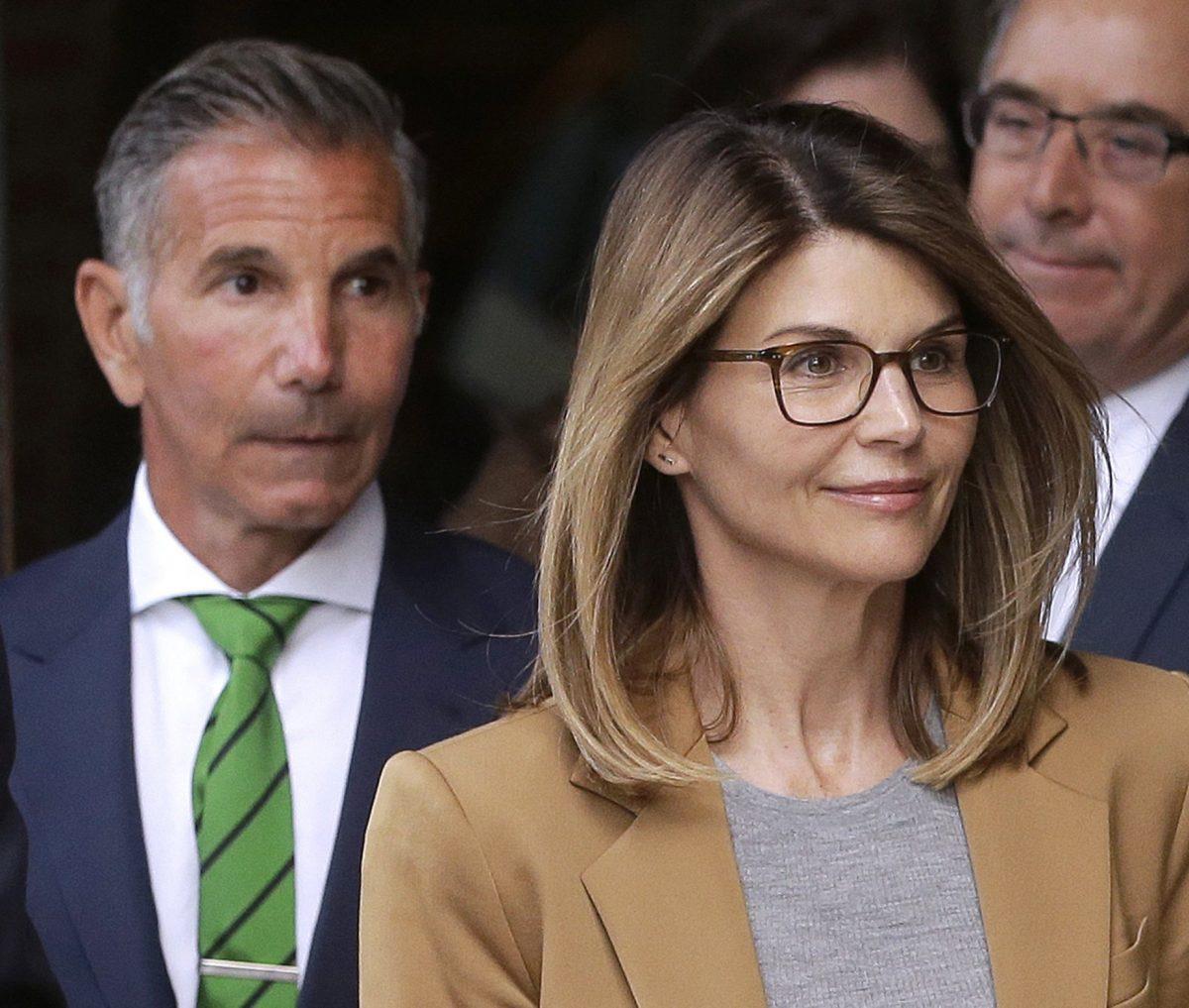 Actress Lori Loughlin and her husband, clothing designer Mossimo Giannulli (L) depart federal court in Boston, on April 3, 2019. (Steven Senne/AP photo)
