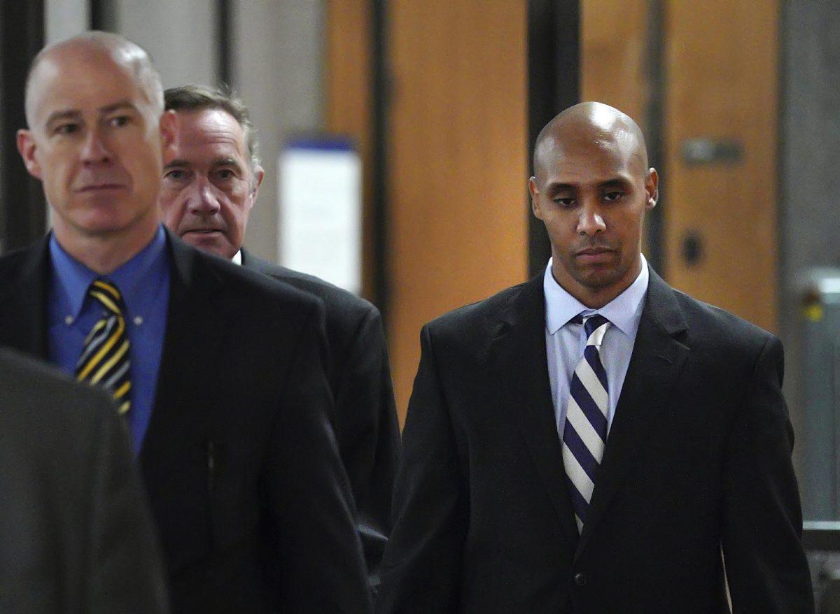 Former Minneapolis police officer Mohamed Noor, right, with attorneys Peter Wold, center, and Thomas Plunkett, left, walks out of the the Hennepin County Government Center on April 25, 2019. (Brian Peterson/Star Tribune/AP)