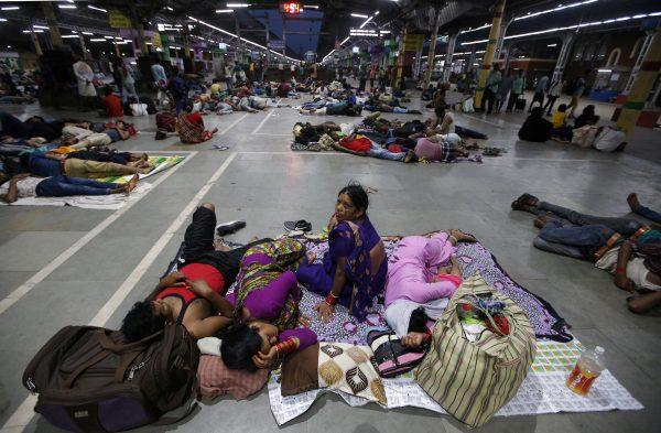 Stranded passengers rest inside a railway station after trains between Kolkata and Odisha were cancelled in Kolkata, India on May 3, 2019. (Rupak De Chowdhuri/Reuters)