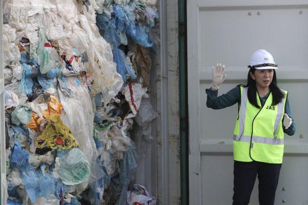 Malaysia's Minister of Energy, Science, Technology, Environment and Climate Change Yeo Bee Yin shows plastic waste shipment in Port Klang, Malaysia,on May 28, 2019. (Vincent Thian/AP Photo)