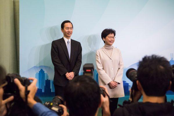 Carrie Lam (R) and her campaign manager, Bernard Chan, pose for photos at a press conference to announce her candidacy for the 2017 Hong Kong Chief Executive elections on January 16, 2017. (ISAAC LAWRENCE/AFP/Getty Images)