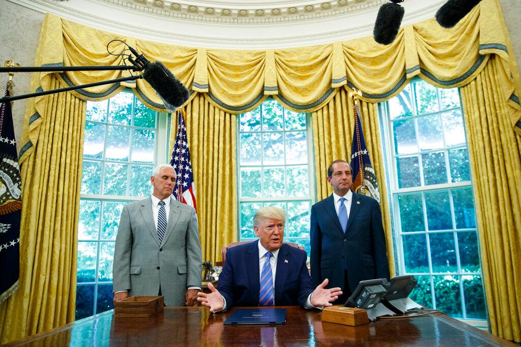President Donald Trump, joined by Vice President Mike Pence (L) and Secretary of Health and Human Services Alex Azar (R), speaks during a signing ceremony in the Oval Office of the White House in Washington on July 1, 2019. (Carolyn Kaster/AP Photo)