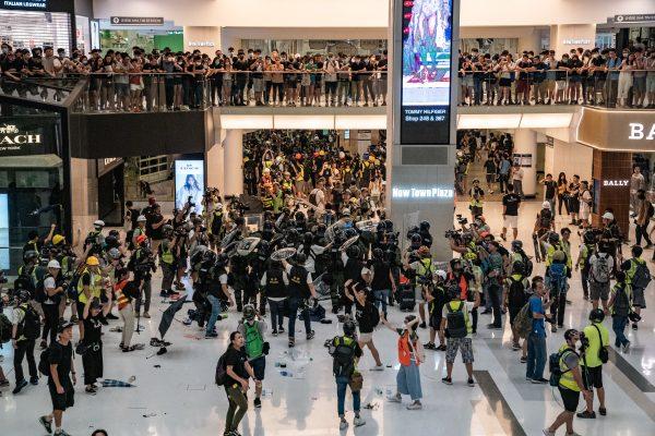 Riot police chase protesters through a shopping mall as they clash with protesters after taking part in a pro-democracy march in the Sha Tin district of Hong Kong on July 14, 2019. (Anthony Kwan/Getty Images)