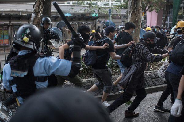 Protesters clash with police after taking part in a march against mainland Chinese parallel traders in the Sheung Shui district of Hong Kong on July 13, 2019. (McGrath/Getty Images)