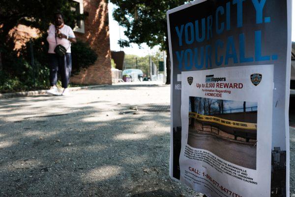 A flyer offers a reward for information on a shooting in the Brownsville neighborhood in Brooklyn where one person was shot and killed and 11 others were injured after two or more shooters opened fire during a massive block party on July 29, 2019. (Spencer Platt/Getty Images)