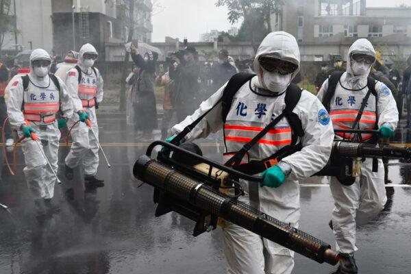Soldiers from military chemical units take part in a drill organized by the New Taipei City government to prevent the spread of the COVID-19 coronavirus, in the Xindian District of New Taipei, Taiwan, on March 14, 2020. (Sam Yeh/AFP via Getty Images)