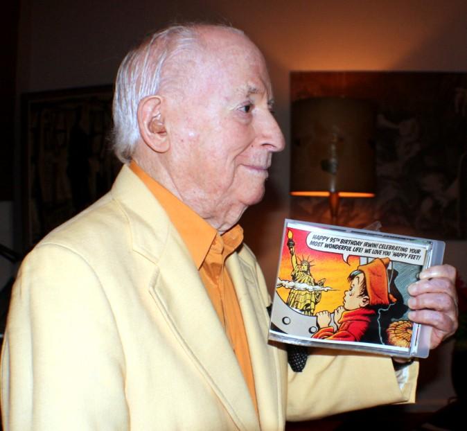 Irwin Hasen with a memento book of pictures and his cartoon art made for his 95th birthday. (Myriam Moran copyright 2014)