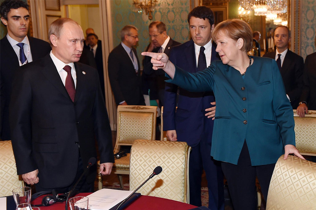 German Chancellor Angela Merkel (R) speaks to Russia's President Vladimir Putin (L) as Italian Prime Minister Matteo Renzi looks on prior to their meeting on Ukraine's crisis with Ukrainian President Petro Poroshenko (not seen), on the sidelines of the 10th Asia–Europe Meeting (ASEM) summit in Milan on Oct. 17, 2014. (Daniel dal Zennaro/AFP/Getty Images)