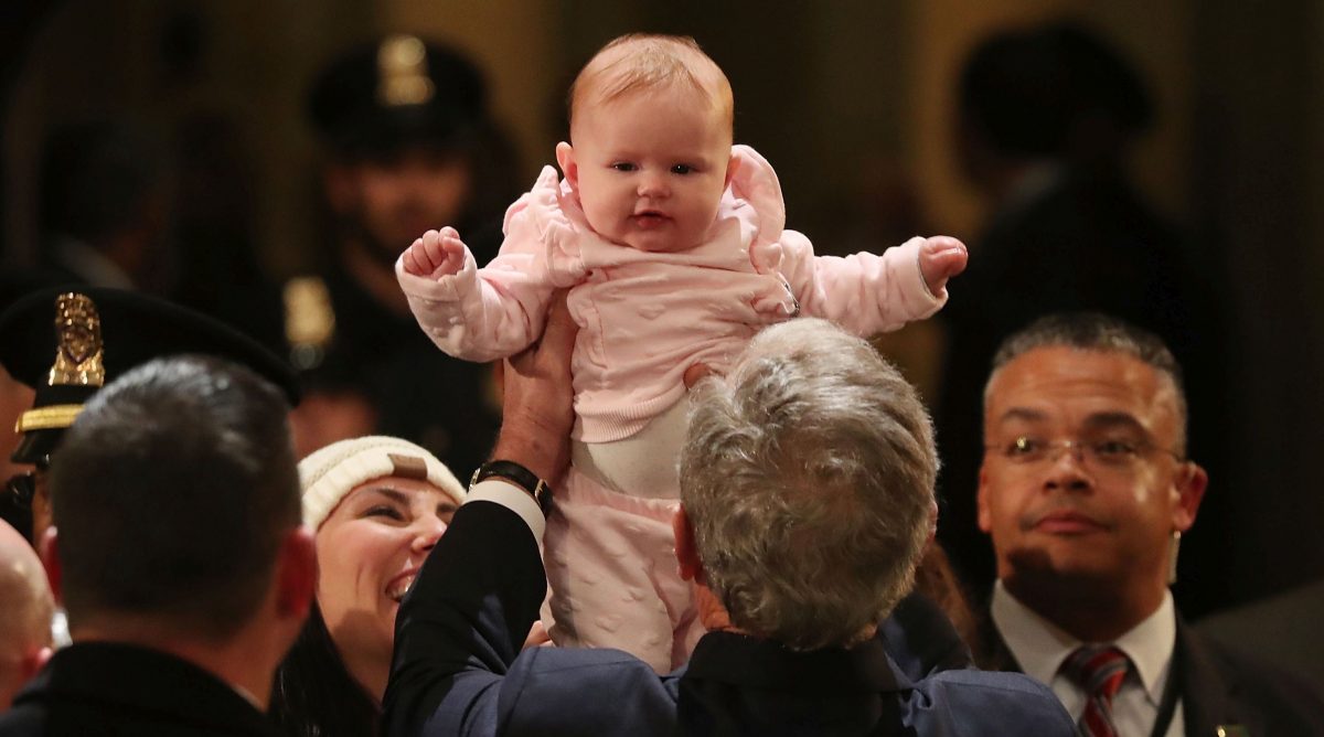 bush holds up a baby